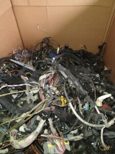 A large box filled with automotive wiring harnesses for scrap recycling at Mid Atlantic Recycling Solutions, LLC in Norfolk, VA.