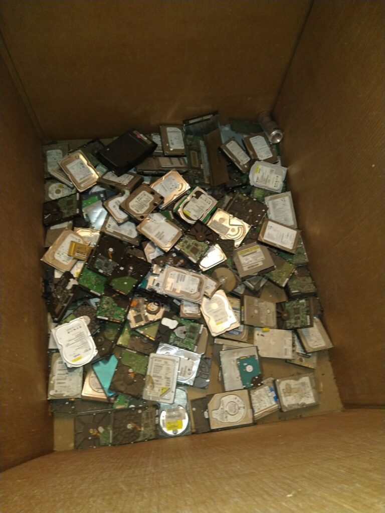A large box filled with computer hard drives for e-waste recycling at Mid Atlantic Recycling Solutions, LLC in Norfolk, VA.