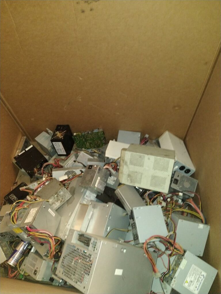 A large box filled with computer power supplies for e-waste recycling at Mid Atlantic Recycling Solutions, LLC in Norfolk, VA.