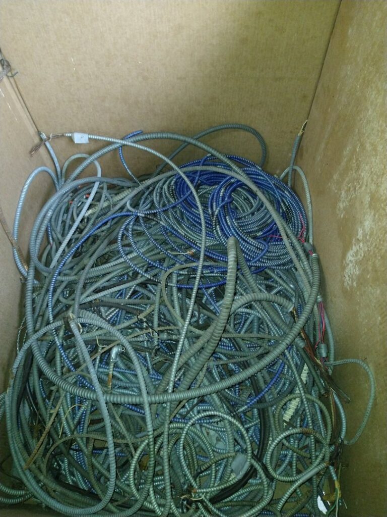 A large box filled with electrical conduit and wiring for scrap recycling at Mid Atlantic Recycling Solutions, LLC in Norfolk, VA.