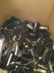 A large box filled with fluorescent light ballasts for recycling at Mid Atlantic Recycling Solutions, LLC in Norfolk, VA.
