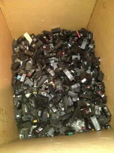 A large box filled with power adapters and chargers for e-waste recycling at Mid Atlantic Recycling Solutions, LLC in Norfolk, VA.