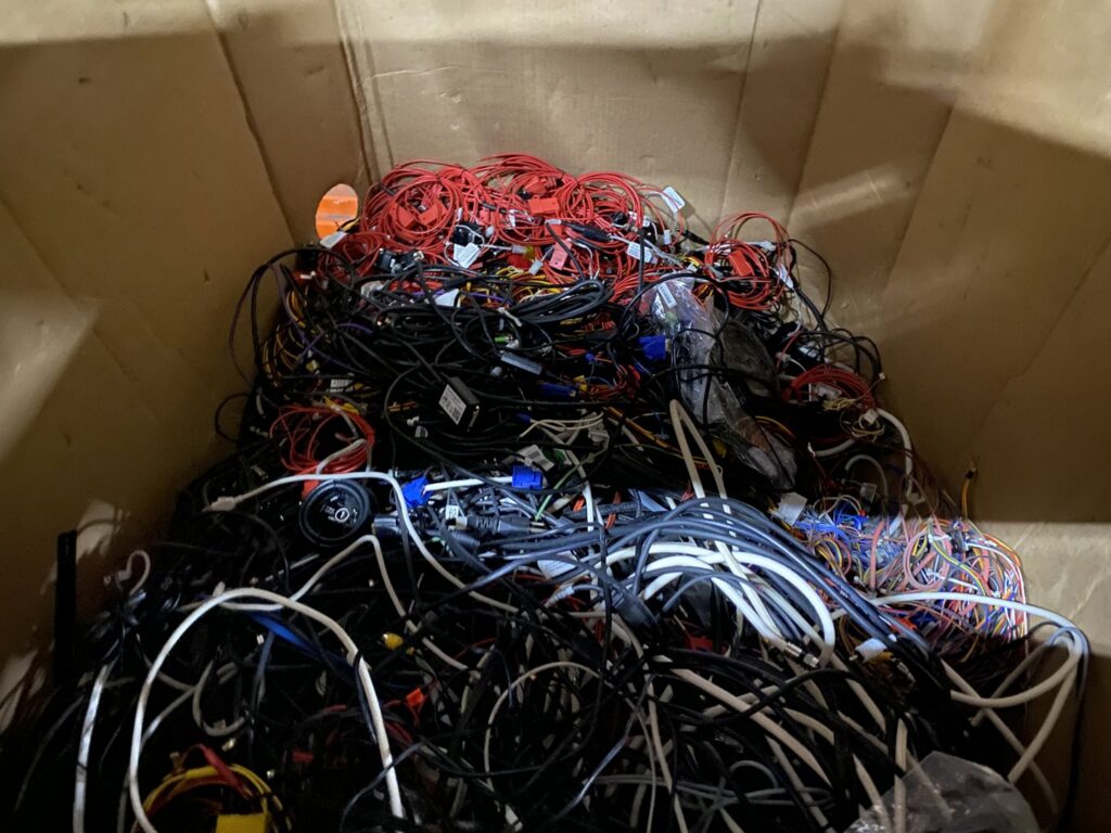 A box full of tangled cables and wires, collected as e-waste by R3Ewaste in Phoenix, AZ