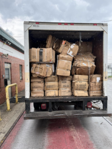 A box truck loaded with baled cardboard boxes at a loading dock for E&k logistics an Recycling LLC in Hoover, AL.