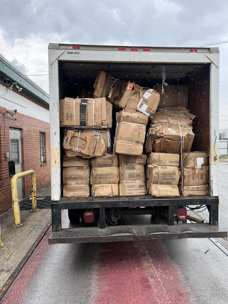 A box truck loaded with baled cardboard boxes at a loading dock for E&k logistics an Recycling LLC in Hoover, AL.