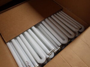 A box filled with U-shaped fluorescent tubes collected for recycling by Quick Light Recycling in South San Francisco, CA.