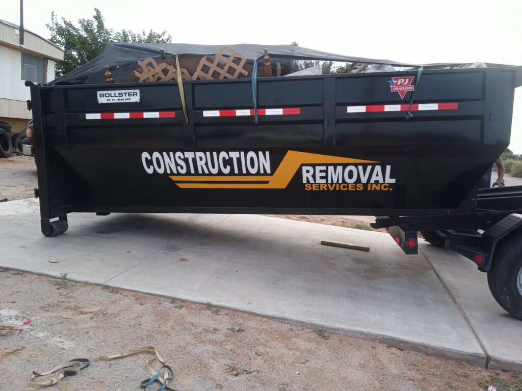 A branded black dump trailer from Construction Removal Services Inc. in El Paso, TX, showcasing their equipment.