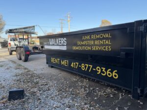 A branded Waste Walkers Dispatch dumpster for junk removal and demolition services in Springfield, MO.