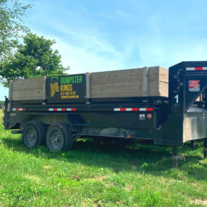 A branded Dumpster Kings LLC dumpster trailer ready for junk removal services in Lansing, MI.