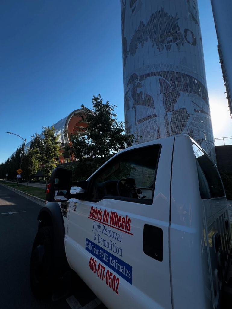 The side of a branded white work truck for Debris On Wheels, offering junk removal in Eugene, OR.