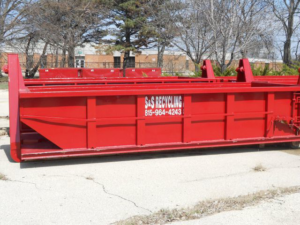 A branded red roll-off dumpster from SS ROLL OFF Dumpsters ready for junk removal in Rockford, IL.