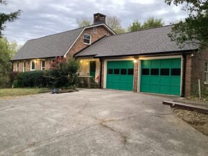 A brick home showcasing a new roof installed by Innovative Roofing & Siding Inc in Knoxville, TN.