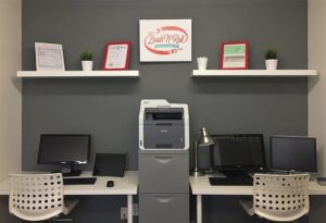 A brick house with three wooden garage doors, showcasing exterior painting by Brush N' Roll Painting Co. in Federal Way, WA.