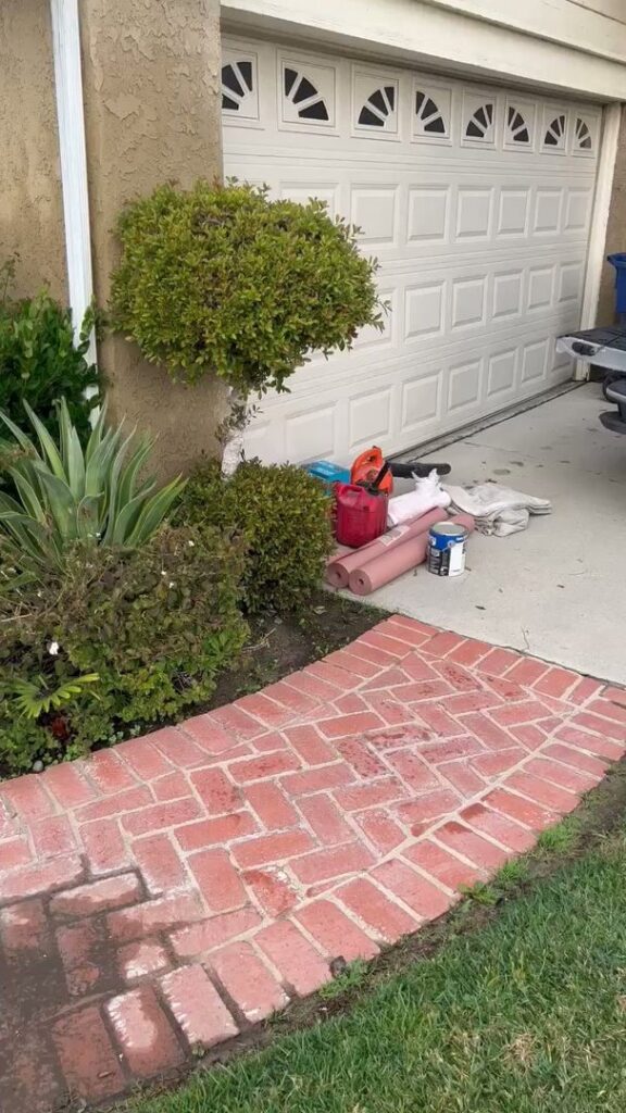 A brick pathway leading to a residential garage, showing exterior work, by Sal Handyman Services in Canyon Country, CA