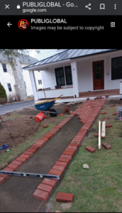 A new brick pathway being installed in front of a house by USA Contractors in Danbury, CT.