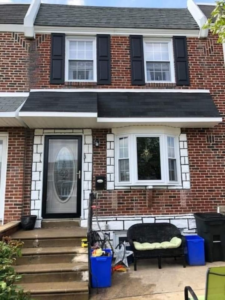 Brick row house exterior remodeling with new awning and windows by M.A.C Construction & Home Remodeling LLC, Philadelphia, PA.