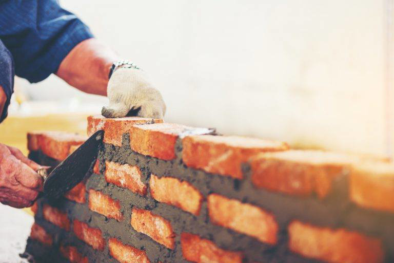 A professional worker performing bricklaying and masonry work for Abbot Building Restoration Co., Inc. in Boston, MA