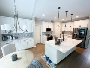 A bright, modern kitchen renovation with white cabinets and a large island by Berco Construction LLC in Godfrey, IL