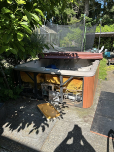 A broken hot tub in a backyard awaiting removal by Grit City Junk llc in Tacoma, WA.