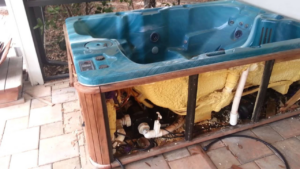 A broken hot tub on a patio, ready for removal by Harvey's Junk Hauling and Recycling LLC in Scottsdale, AZ.
