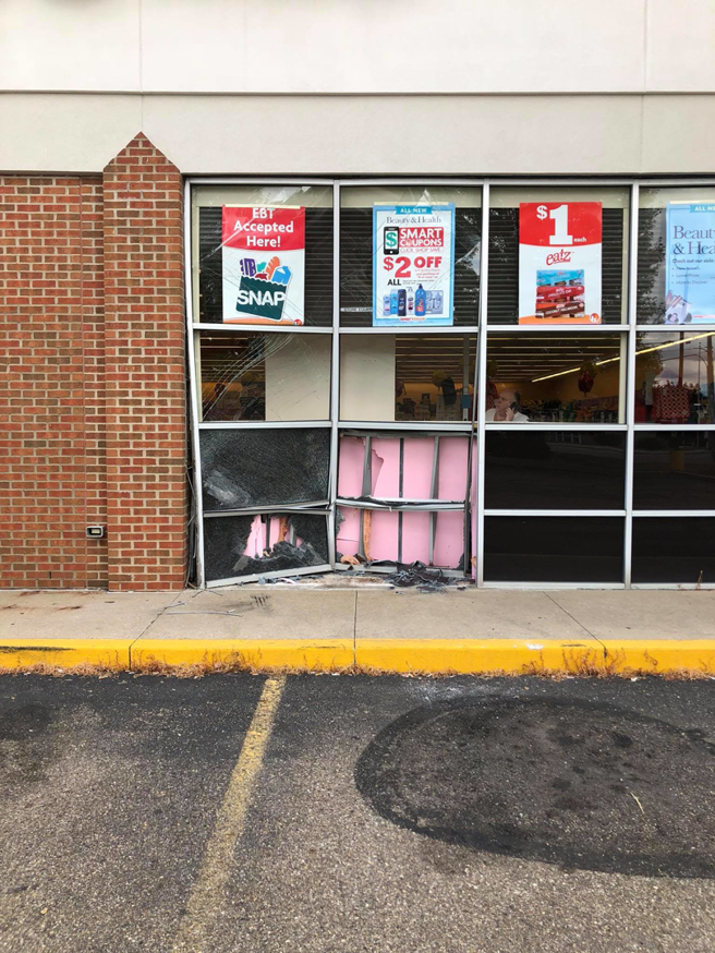 A broken storefront window with shattered glass, showing damage before repair by Master Handyman, LLC in Cleveland, OH.