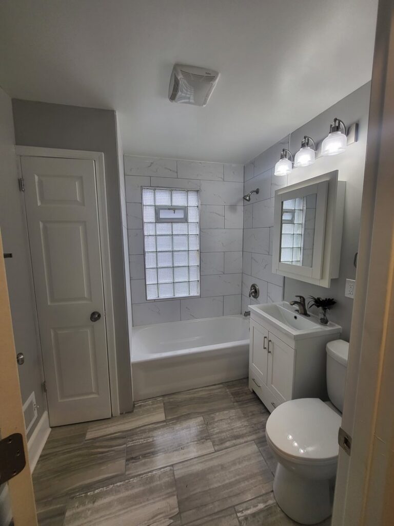 A close-up of a broken wooden fence needing repair, a service offered by Advance Construction Builders, LLC in Milwaukee, WI.