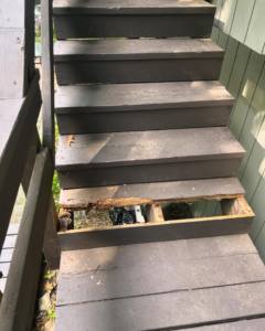 A broken wooden stair step needing repair, a service offered by Blackcap Handyman in Portland, ME.