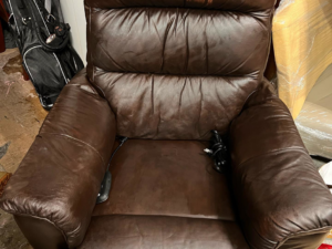 A bulky brown leather recliner chair ready for general junk removal service by Junk2Dump in Sacramento, CA.