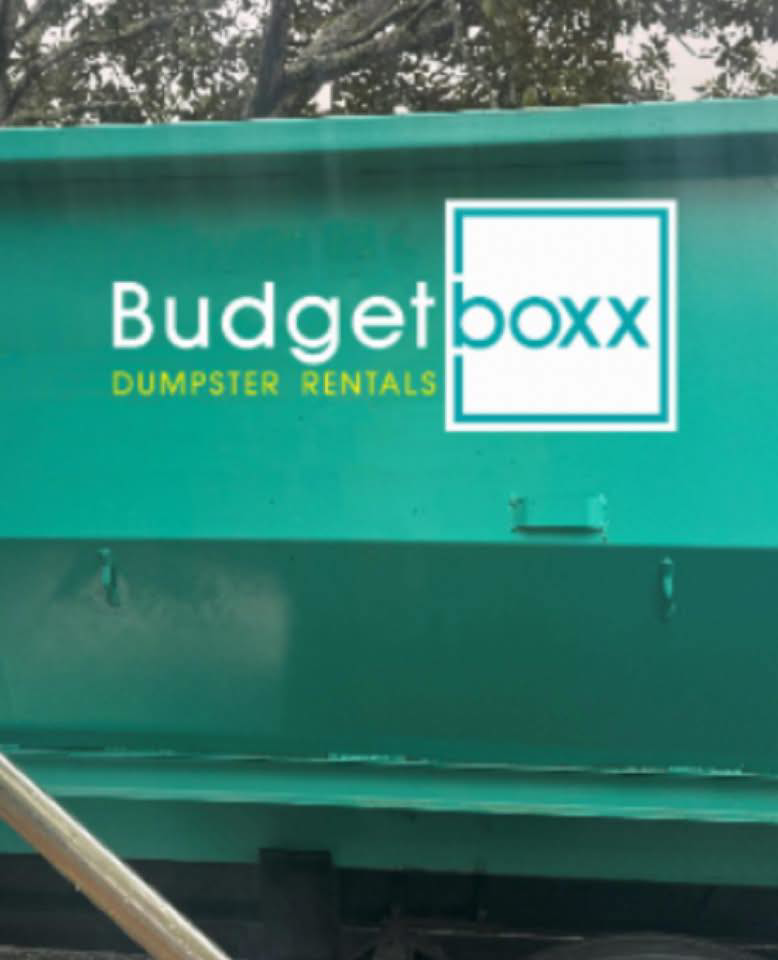 A close-up of a green Budget Boxx dumpster with the company logo for junk removal services in Suffolk, VA.