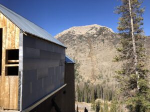A building under construction with new metal roofing and siding by Deep Roots Craftsmen in Fort Collins, CO.