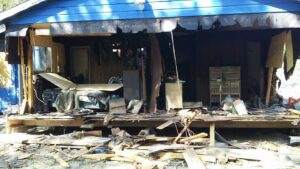 A building undergoing demolition with debris scattered around, handled by All Aboard Contractors in Houston, TX.