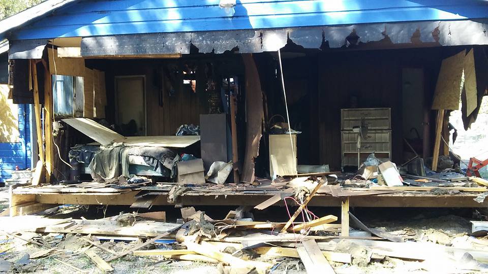 A building undergoing demolition with debris scattered around, handled by All Aboard Contractors in Houston, TX.