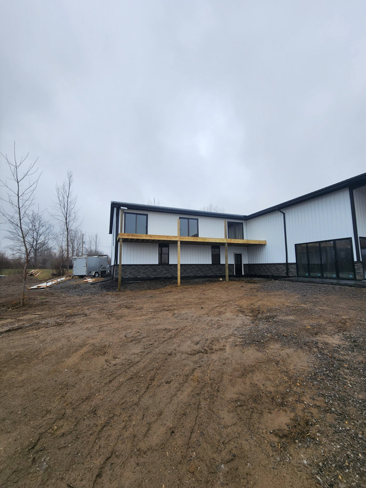 The exterior of a building with a large deck under construction, a project by J and R Contracting in Buffalo, NY.