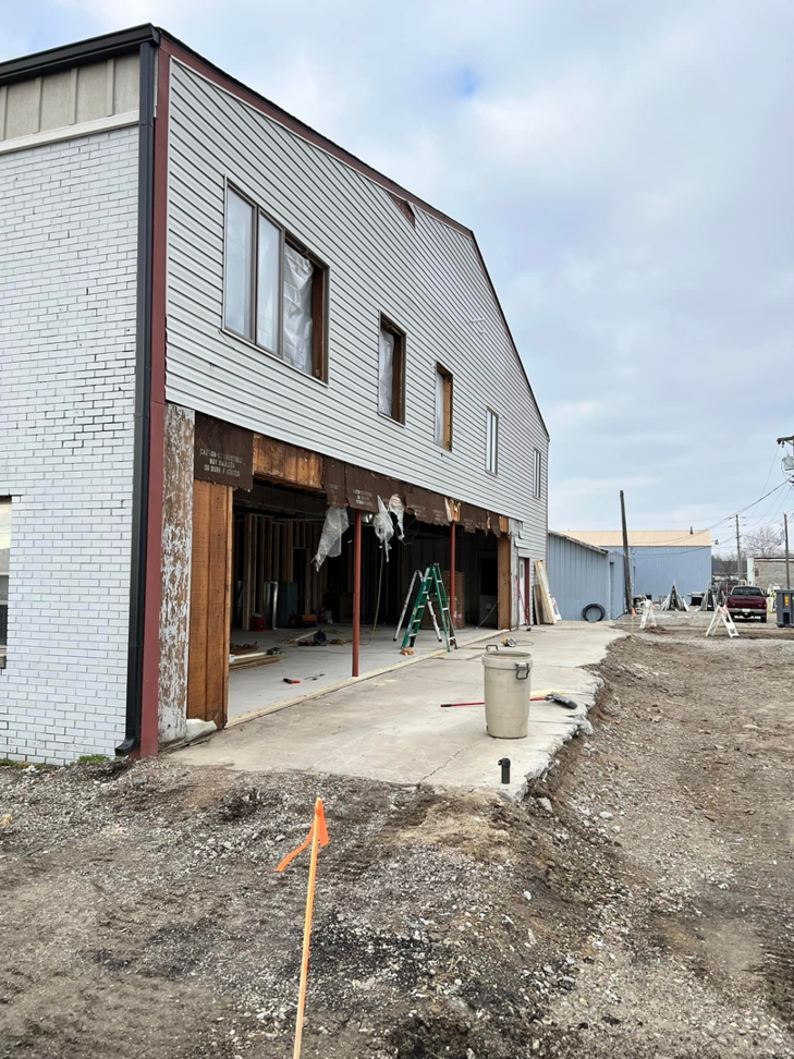Building exterior undergoing heavy renovation with exposed structure and supports by American Enterprises Inc. in Waunakee, WI.