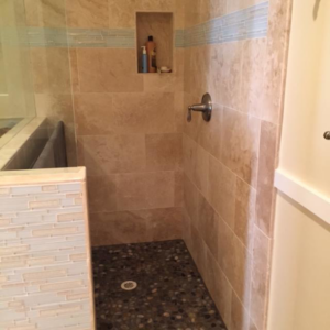 A beautifully installed built-in bathtub with a tiled surround and steps, a project by Holland Construction LLC in Tucson, AZ.