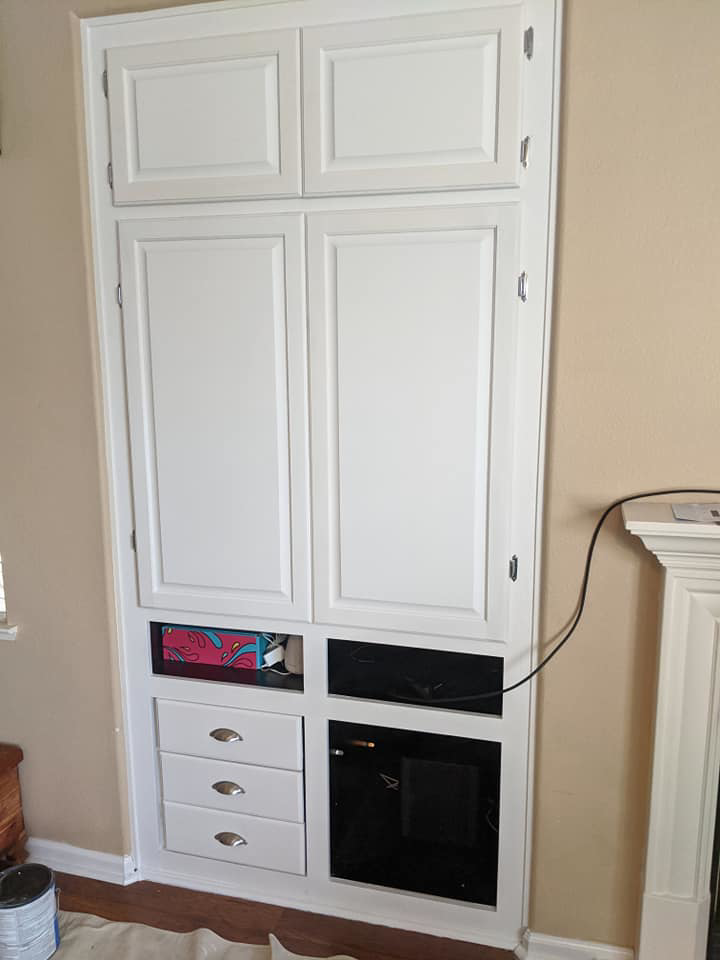 A newly installed white built-in cabinet unit with drawers and shelves by Capstone Handyman in Sacramento, CA
