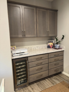Custom built-in cabinets with a white countertop and integrated wine fridge by Arizona Cabinet & Countertop Company in Tucson, AZ.