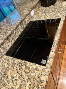 A built-in cooktop with a downdraft ventilation system installed by R&J Handyman Services LLC in Warwick, RI.