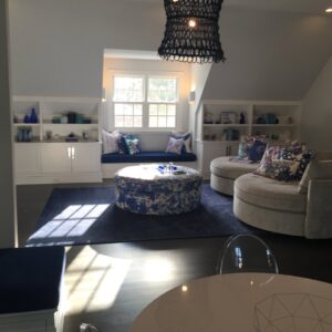 Custom built-in shelving and a window seat installed in a living area by Connaughton Construction in Waltham, MA