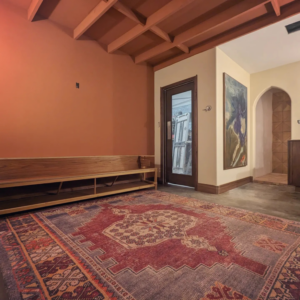 Interior room with a custom built-in wooden bench and painted walls by Gilbert Designs Tulsa, OK.
