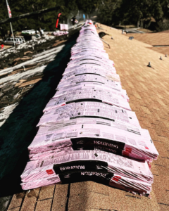 Bundles of new roofing shingles stacked on a roof, ready for installation by Charleston Roofs & Windows in North Charleston, SC.