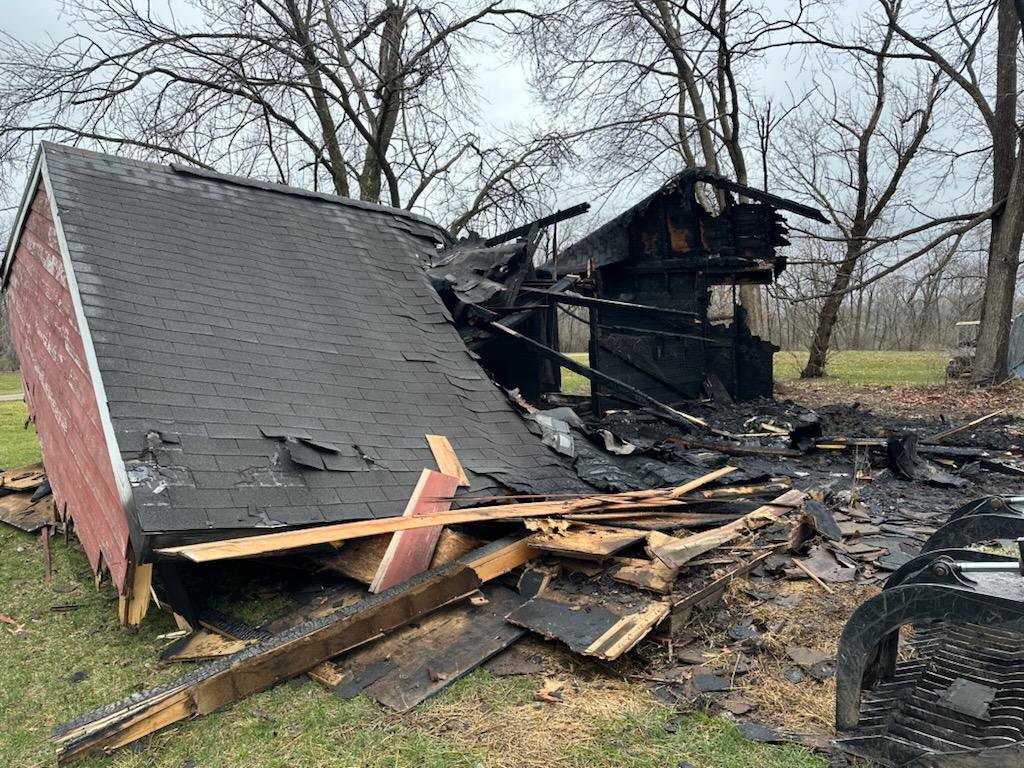A partially collapsed and burned structure, showing demolition debris removal by All Seasons Junk Removal & Dumpster Services in Center Point, IA.