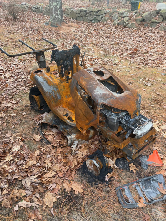 A burnt riding lawnmower ready for removal by Junk Dunkers in Wrentham, MA