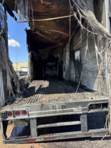 Interior of a burnt truck trailer, showing debris that requires cleanup by Skunky's Junk Removal in Tempe, AZ.