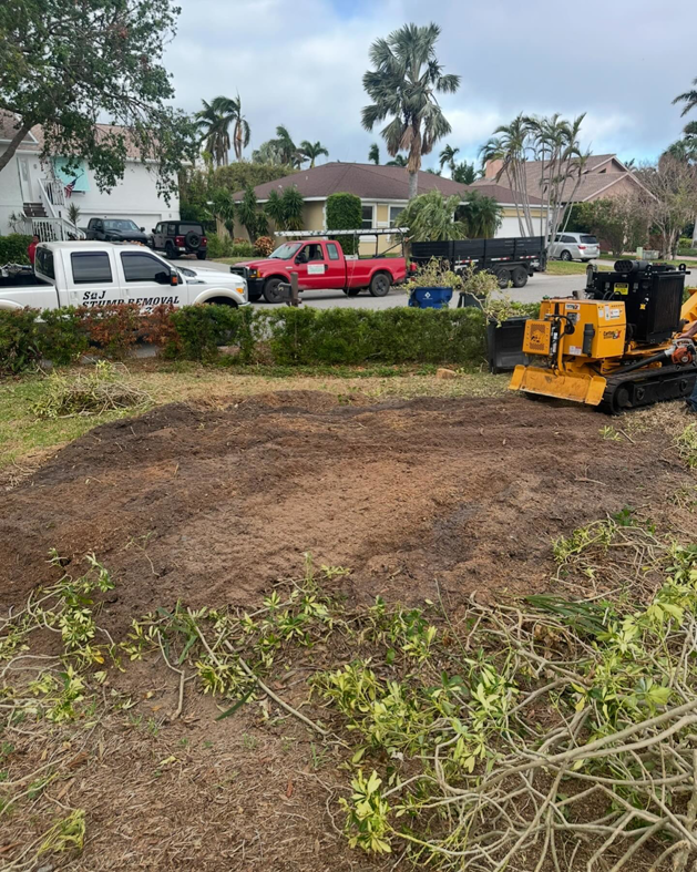 S & J Stump Removal LLC truck and stump grinder at a job site in Shreveport, LA, after a stump removal service.