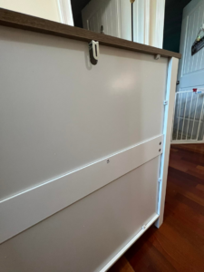 Close-up view of a back panel being installed on a cabinet during furniture assembly by Assembly Required in Summerville, SC.