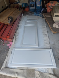 Cabinet doors laid out on a drop cloth for painting or refinishing by Capstone Handyman in Sacramento, CA