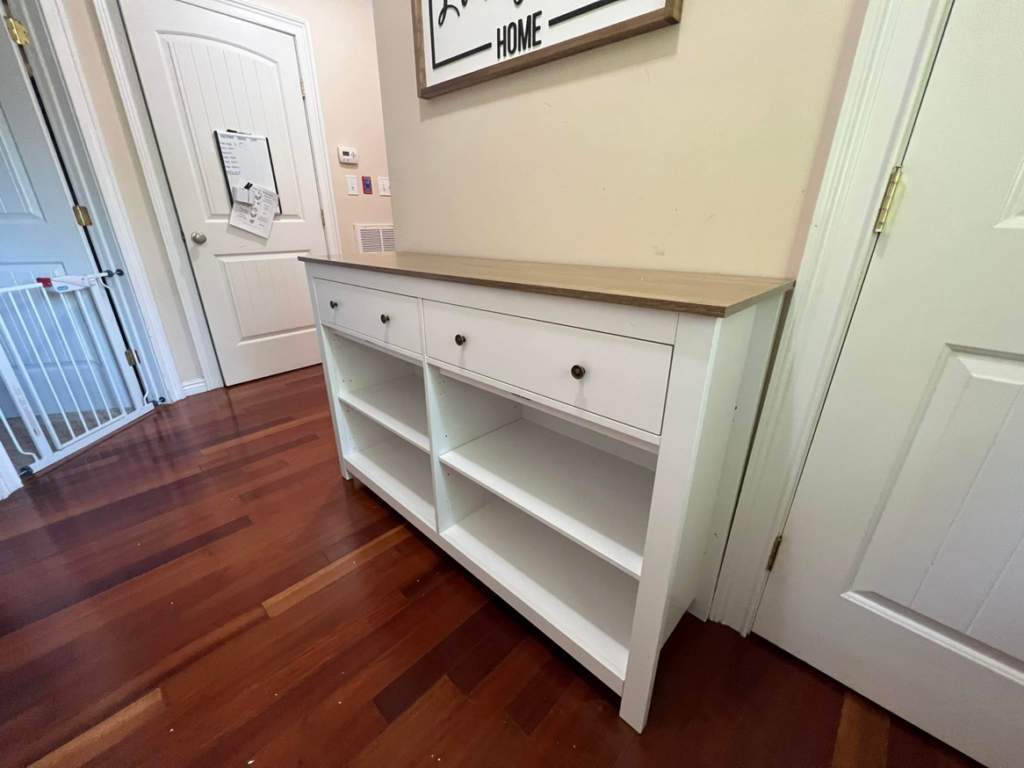 A white cabinet frame partially assembled with drawers installed, showcasing the progress of furniture assembly by Assembly Required in Summerville, SC.