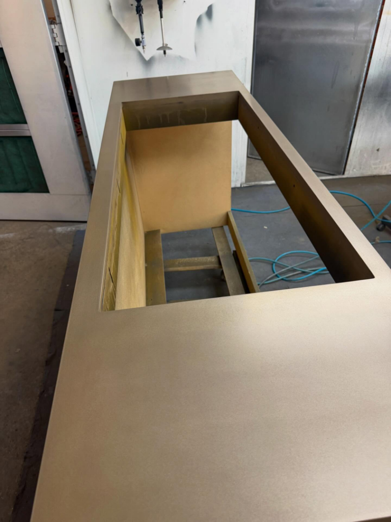 An unfinished cabinet in a spray booth, prepared for painting by Bespoke Finish in Minneapolis, MN.