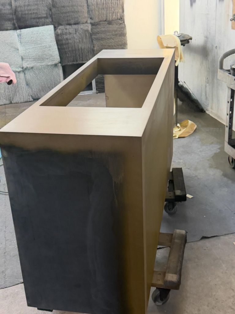 A cabinet being primed or painted in a workshop by Bespoke Finish, a handyman service in Minneapolis, MN.
